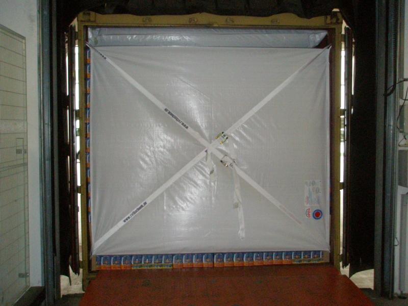 Retaining tarpaulin in overseas container